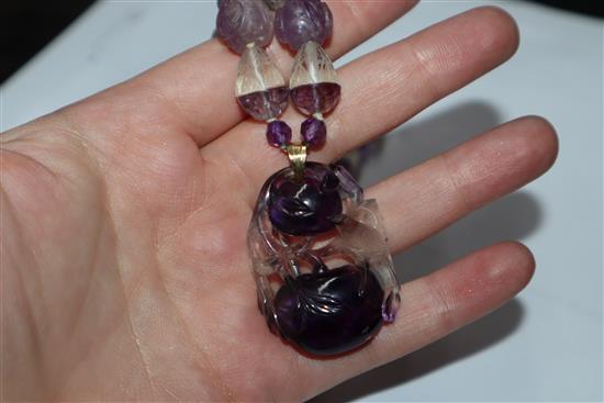 A Chinese amethyst and rock crystal pendant hung from a carved amethyst and rock crystal necklace, pendant 38mm.